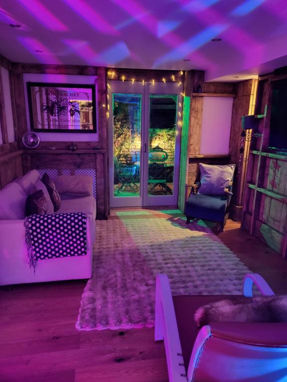 a living room with purple lights and a couch at The Seaside Hideaway St Leonards in Hastings