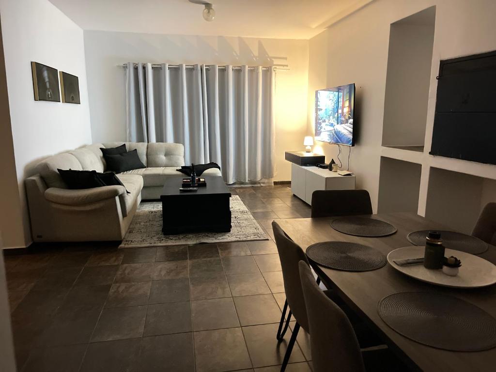 a living room with a couch and a table at Hilo Family Accomodation in Swakopmund