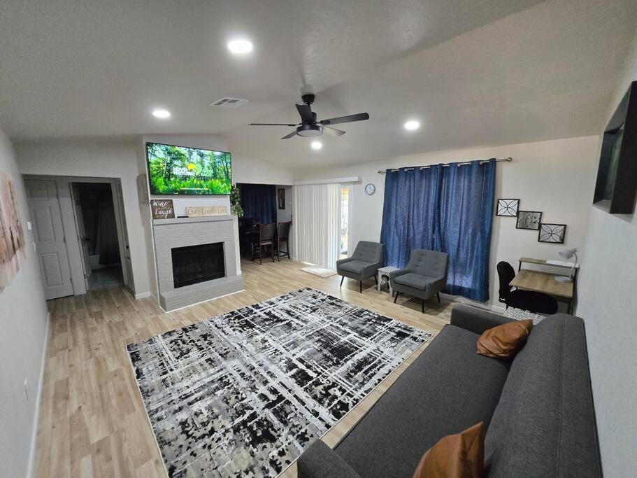 a living room with a couch and a flat screen tv at Comfort Home WiFi n Hottub in Midwest City