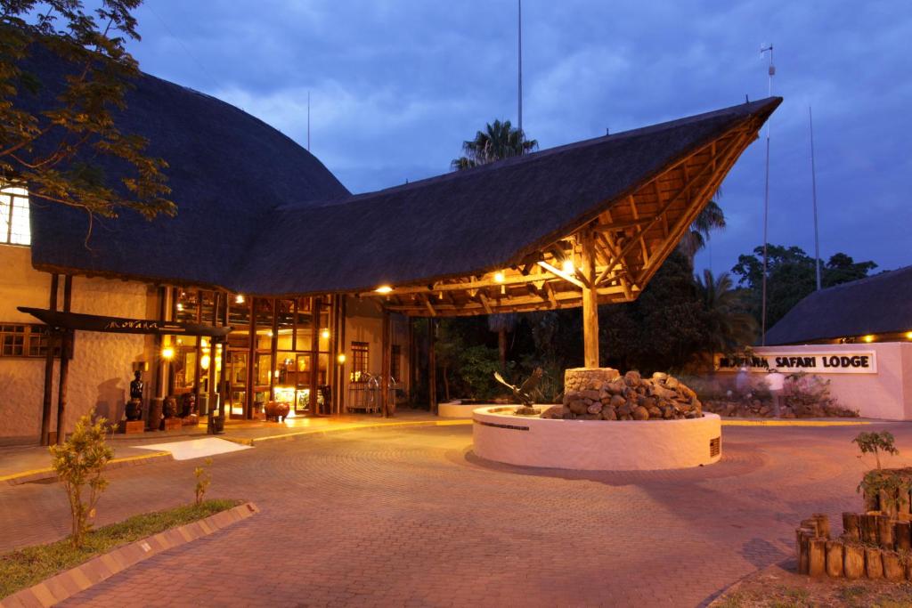 a large building with a large triangular roof at Cresta Mowana Safari Resort & Spa in Kasane