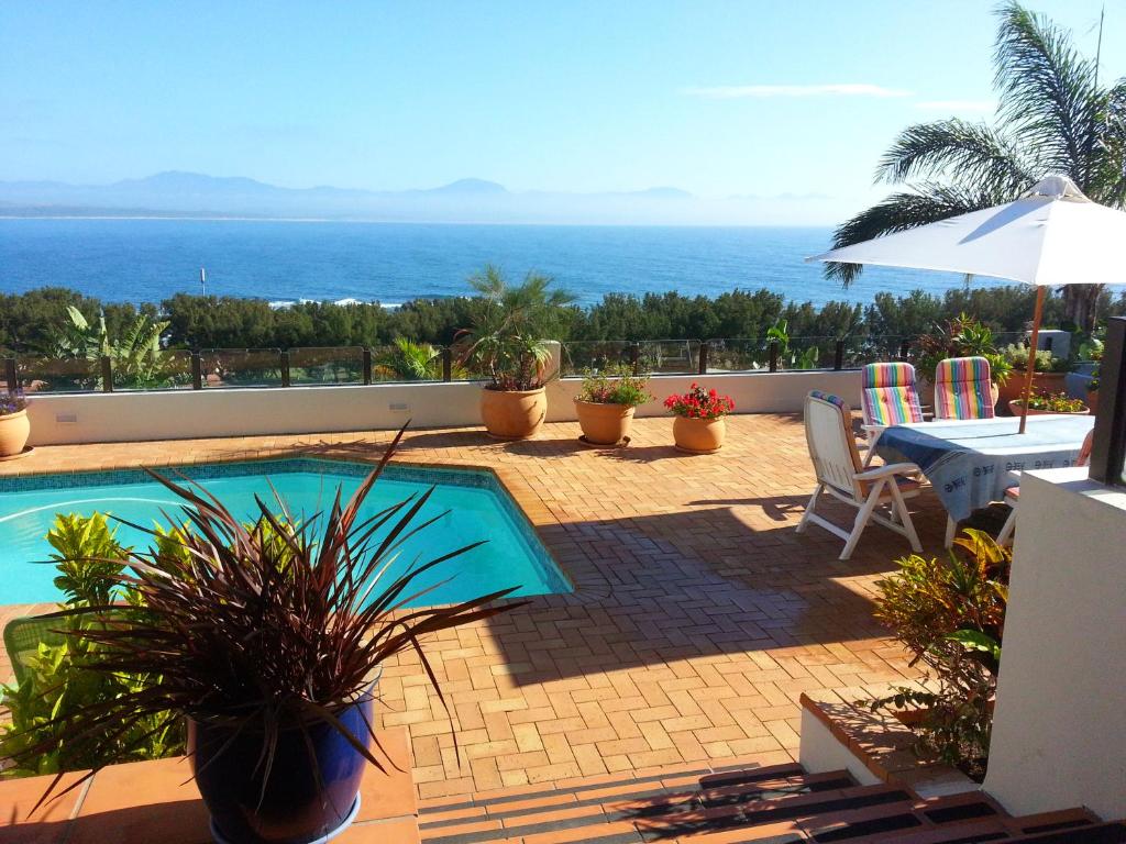 a swimming pool with a view of the ocean at 59 LongSantos in Mossel Bay