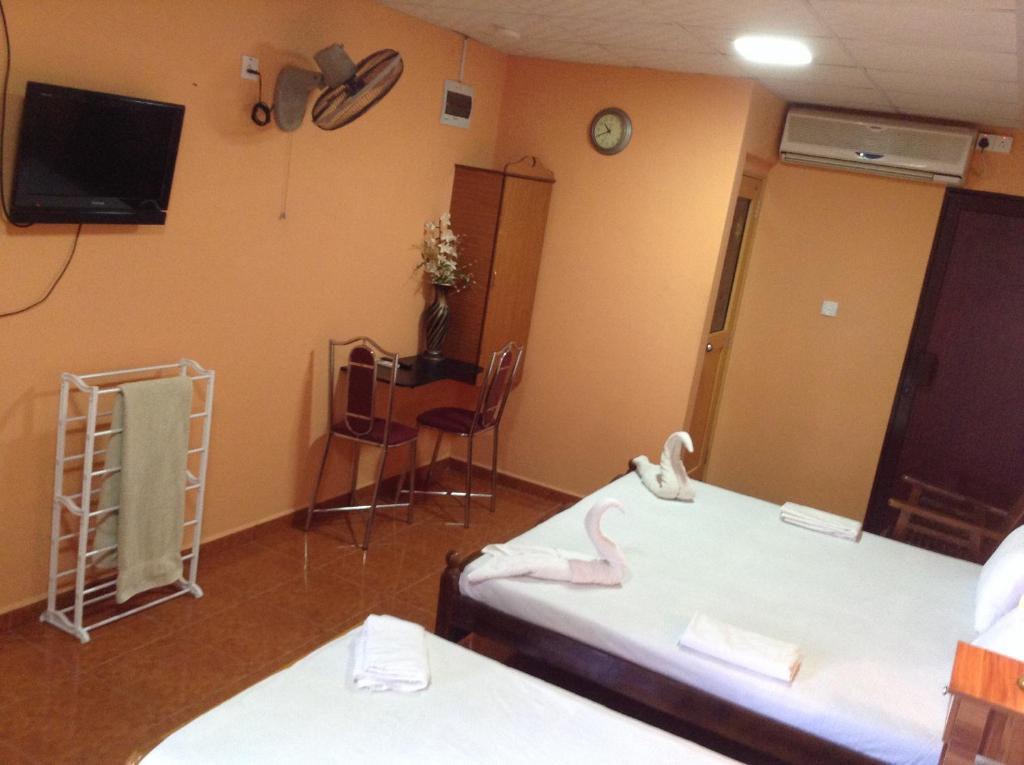 Postel nebo postele na pokoji v ubytování Sunshine Hotel