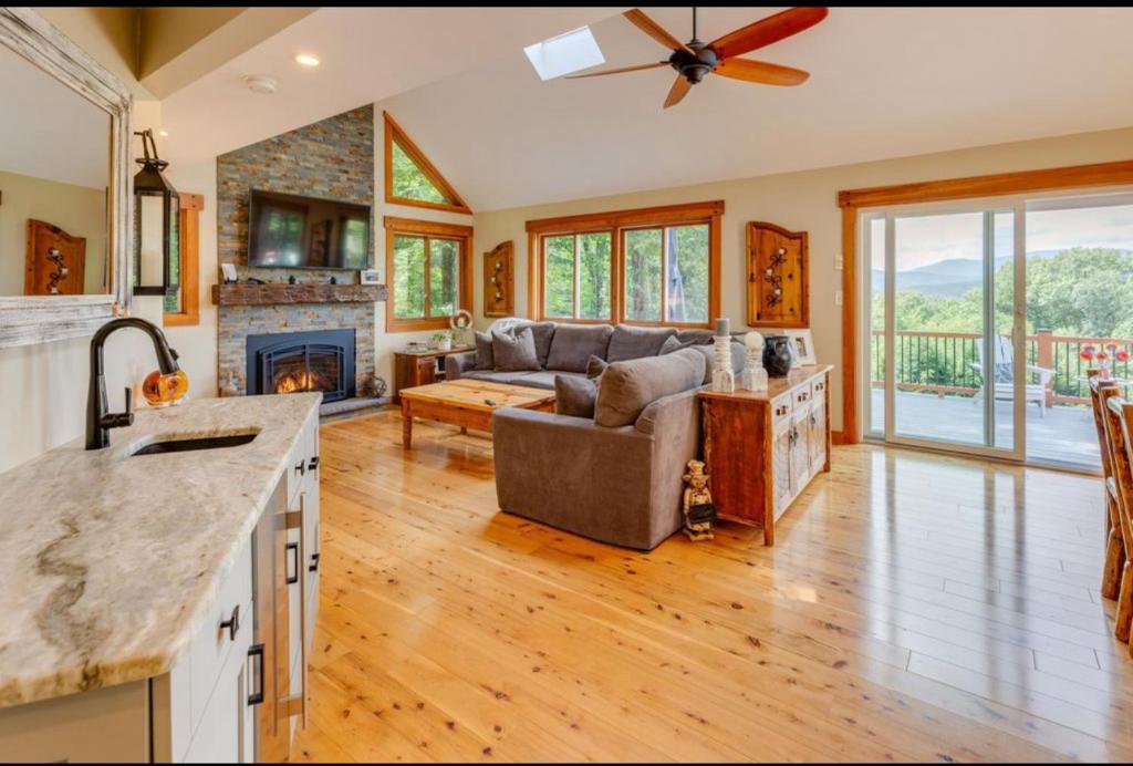a kitchen and living room with a couch and a fireplace at Fireplace Fire Pit Ski 5 Mountains 4BR Views in Thornton