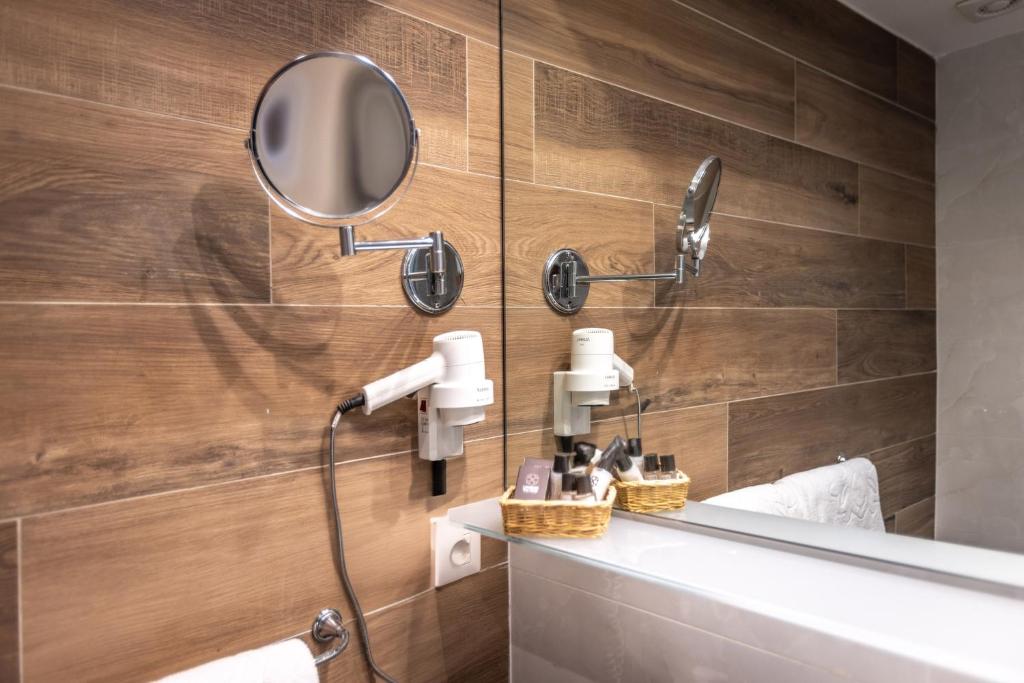 a bathroom with a shower and a mirror at Hotel Villa Margherita in Limone sul Garda