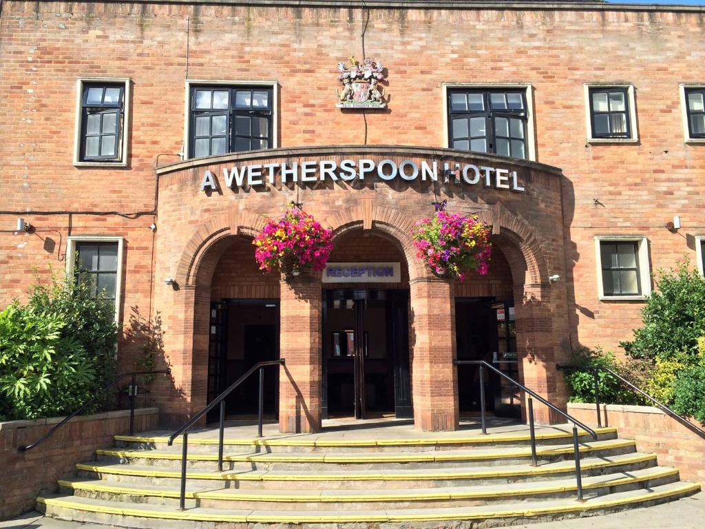 a wehers room hotel with stairs in front of it at The Brocket Arms Wetherspoon in Wigan