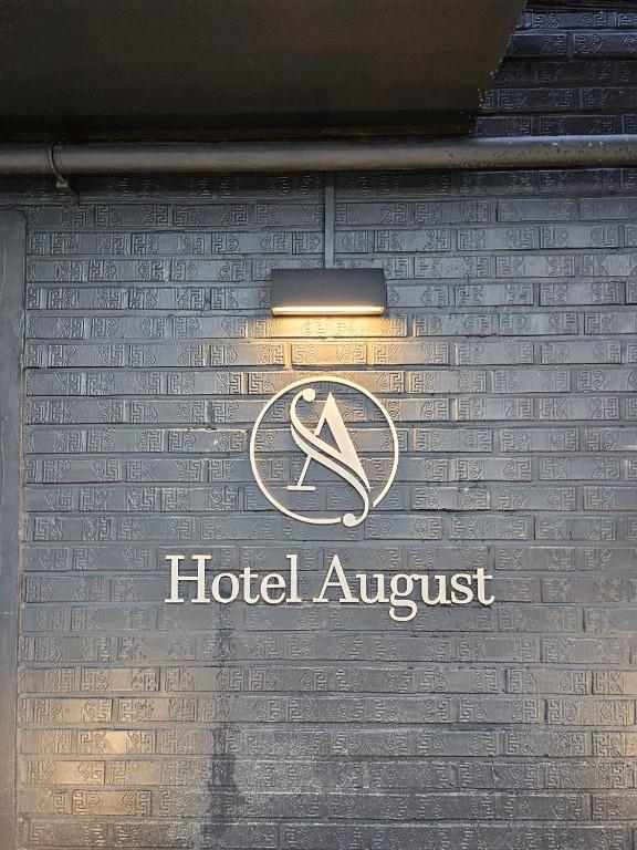 a sign on the side of a building with a hotel insurer at Hwagok August in Seoul
