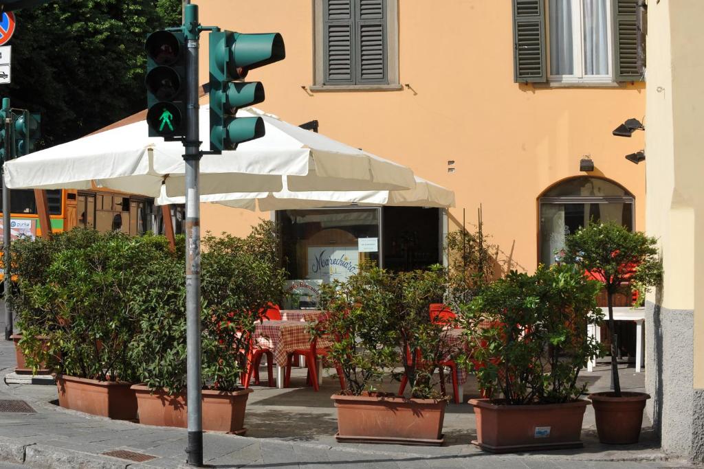 a traffic light with potted plants in front of a building at B&B Sant'Antonio De Foris in Bergamo