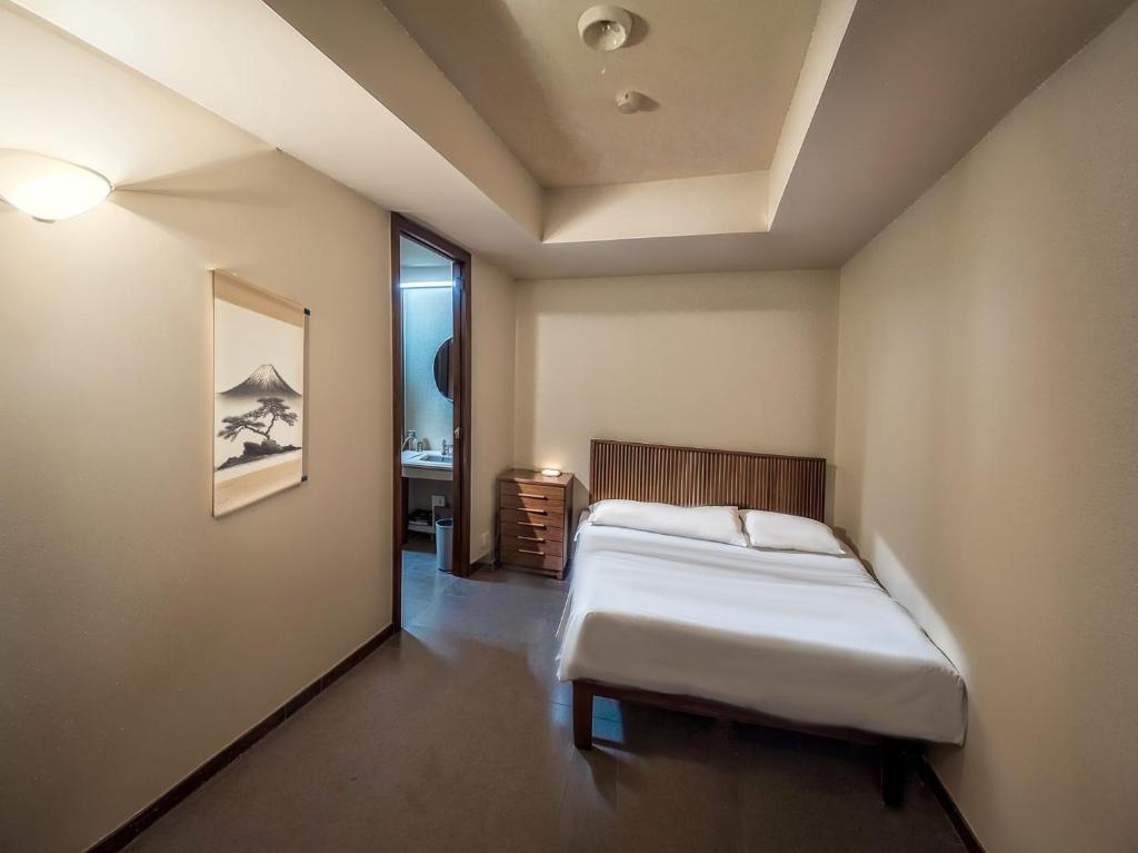 Postel nebo postele na pokoji v ubytování Wonderwall美好境界 日本苗場館