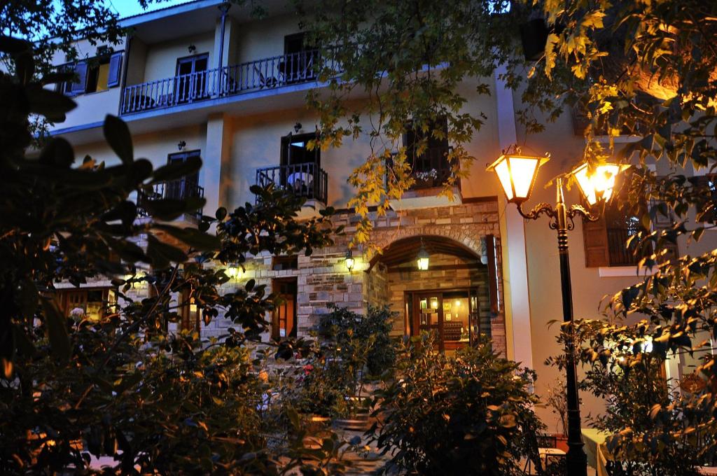 a building with a street light in front of it at Pelias Hotel in Portaria