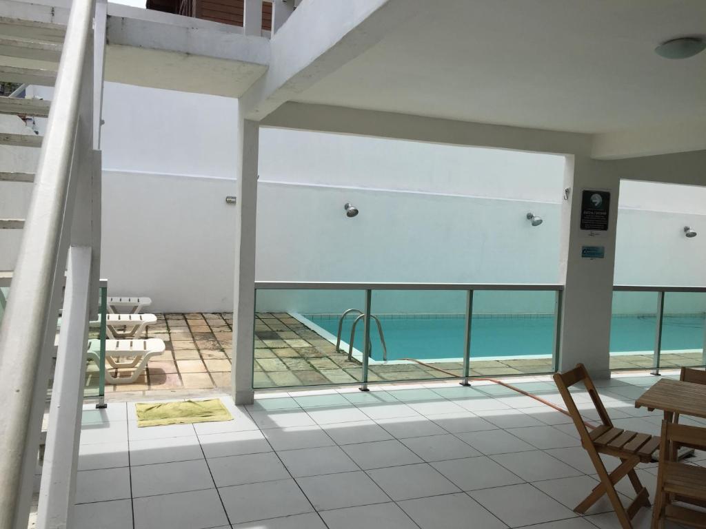 a balcony with a view of a swimming pool at Pousada Praia Grande in Arraial do Cabo