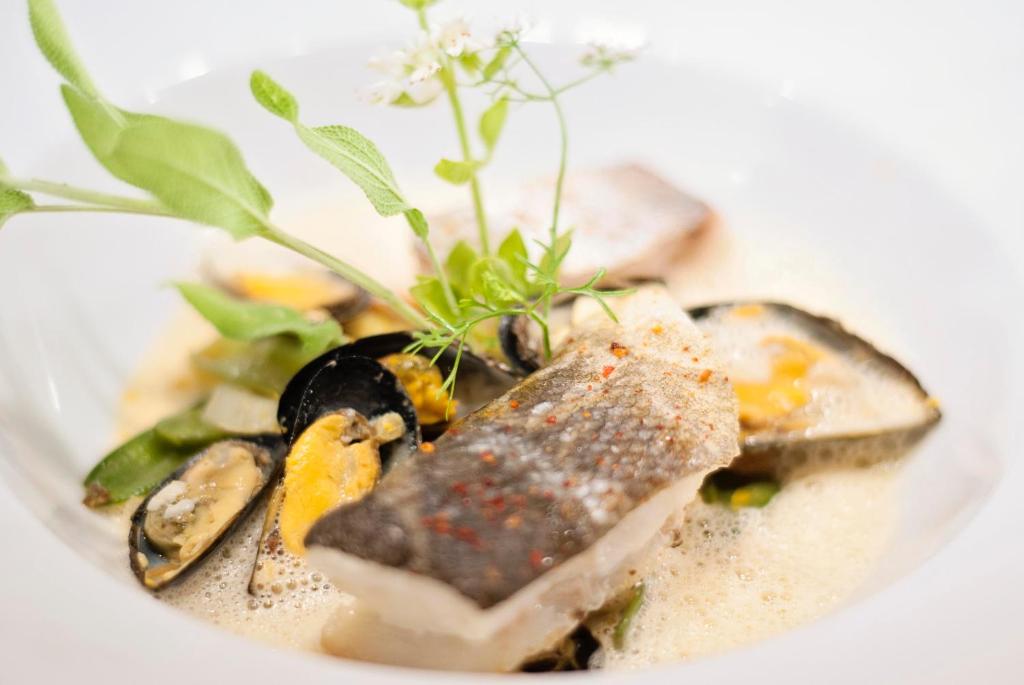 a plate of food on a white plate at Hôtel Restaurant & Spa Plaisir in Le Bois-Plage-en-Ré