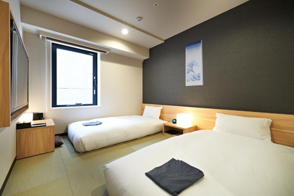 Postel nebo postele na pokoji v ubytování HOTEL Enmichi