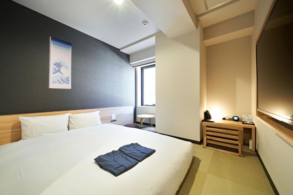 Postel nebo postele na pokoji v ubytování HOTEL Enmichi