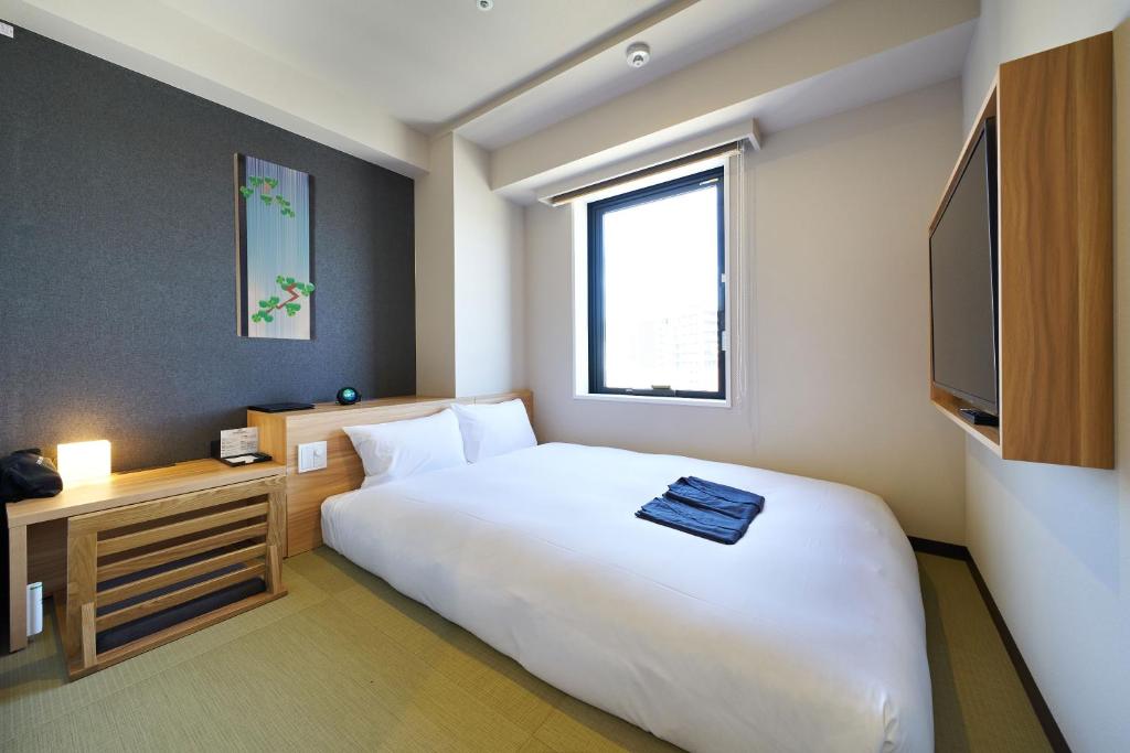 Postel nebo postele na pokoji v ubytování HOTEL Enmichi