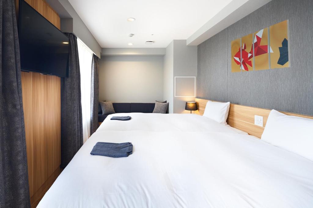 Postel nebo postele na pokoji v ubytování HOTEL Enmichi