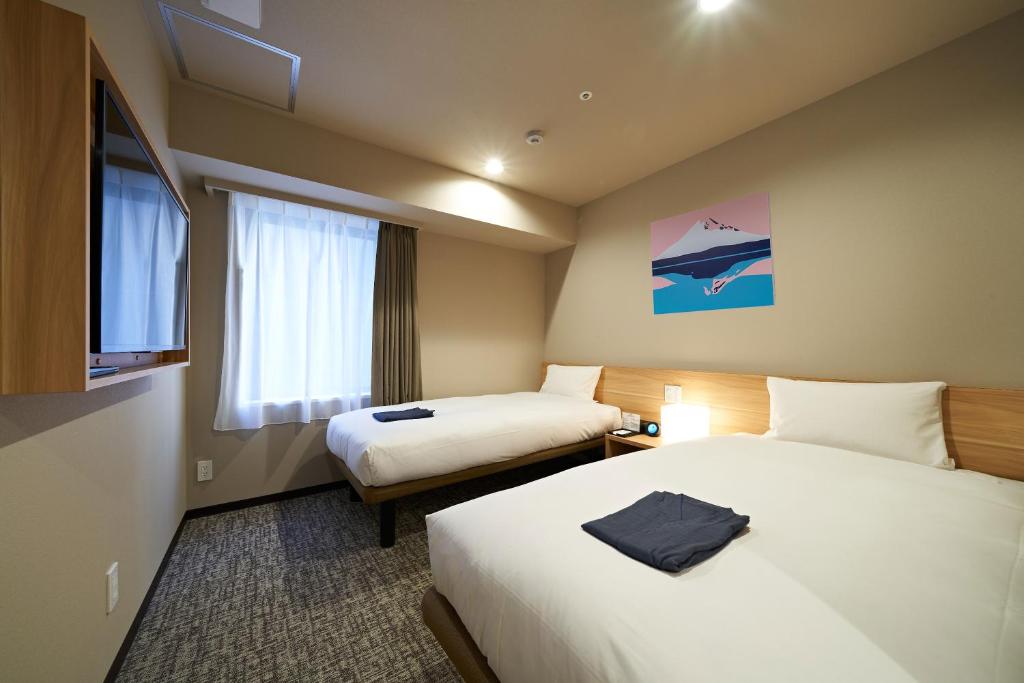 Postel nebo postele na pokoji v ubytování HOTEL Enmichi
