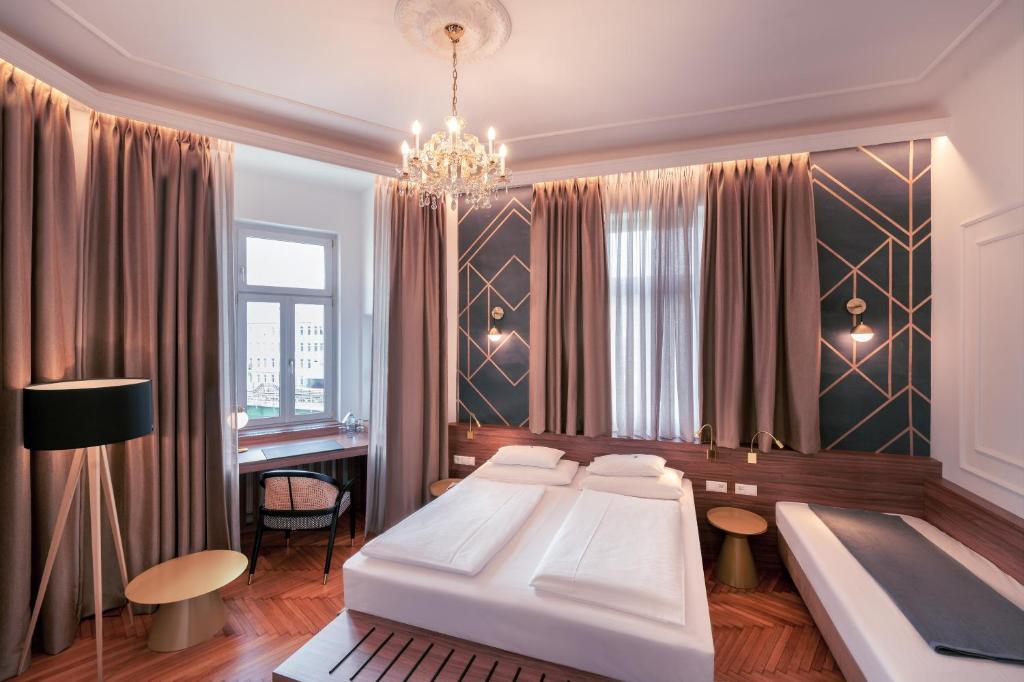 Posteľ alebo postele v izbe v ubytovaní BoutiqueHOTEL Donauwalzer