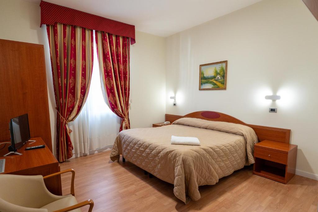 Postel nebo postele na pokoji v ubytování Hotel Cavour Resort