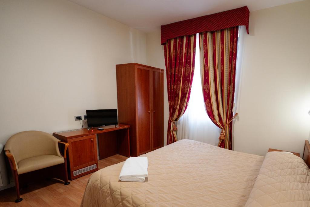 Postel nebo postele na pokoji v ubytování Hotel Cavour Resort