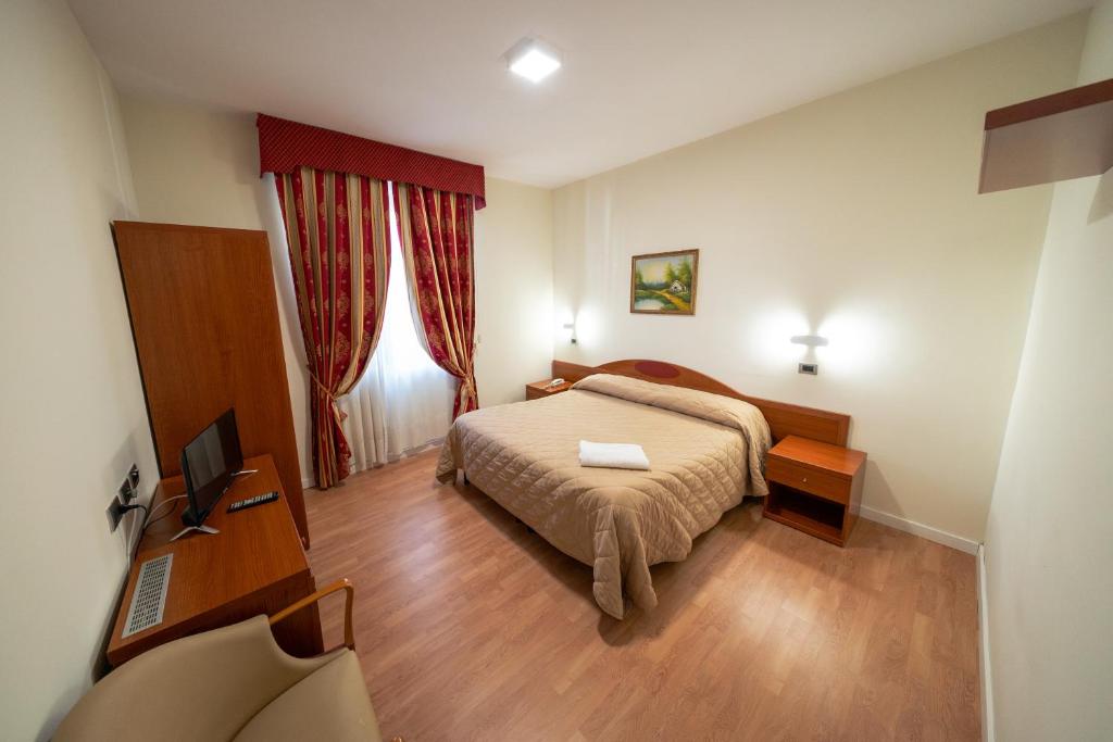 Postel nebo postele na pokoji v ubytování Hotel Cavour Resort
