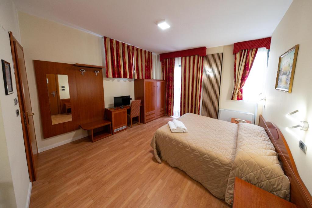 Postel nebo postele na pokoji v ubytování Hotel Cavour Resort