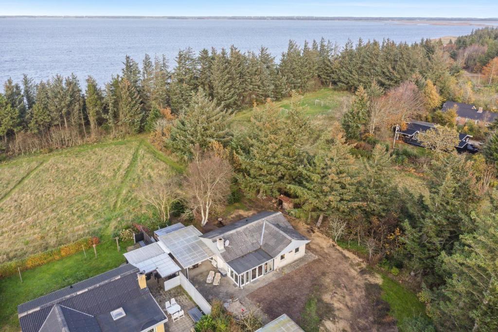 an aerial view of a house on a hill next to the water at Feriehus 1086 in Ulfborg