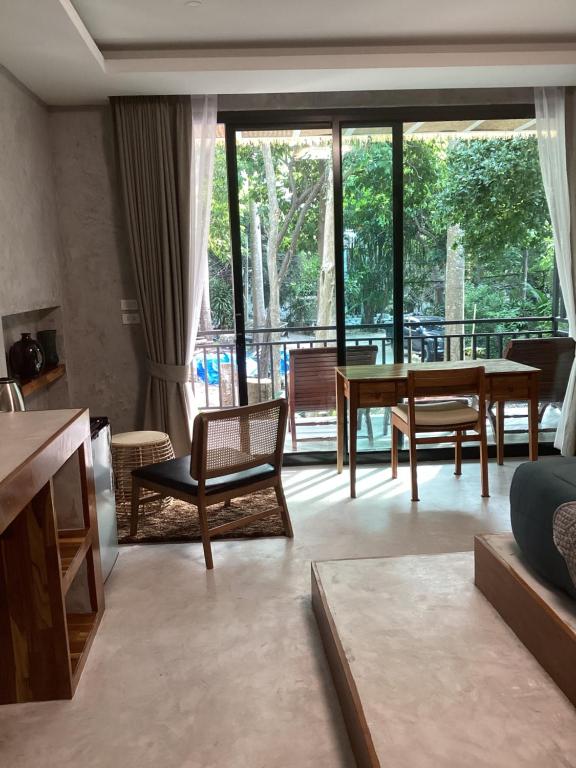 a living room with a table and chairs at Flower Resort in Koh Tao