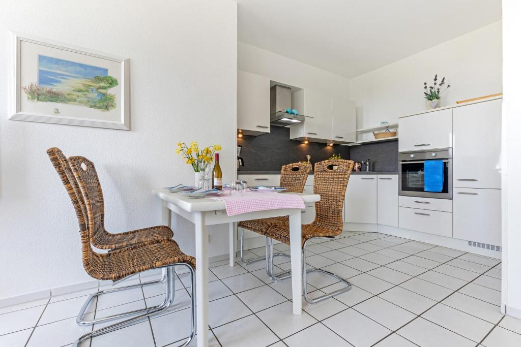 a kitchen with a white table and chairs at "Ferienhof Sporleder" - Bauernhaus 2 in Meeschendorf
