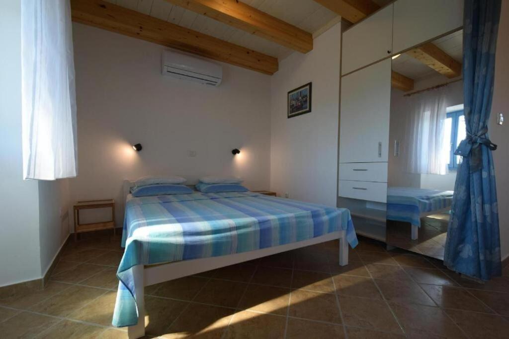 Postel nebo postele na pokoji v ubytování Apartments Insula Insule