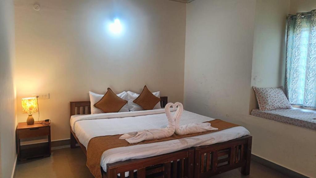 a bedroom with a bed with a towel on it at Heritage Farm Kerala in Idukki