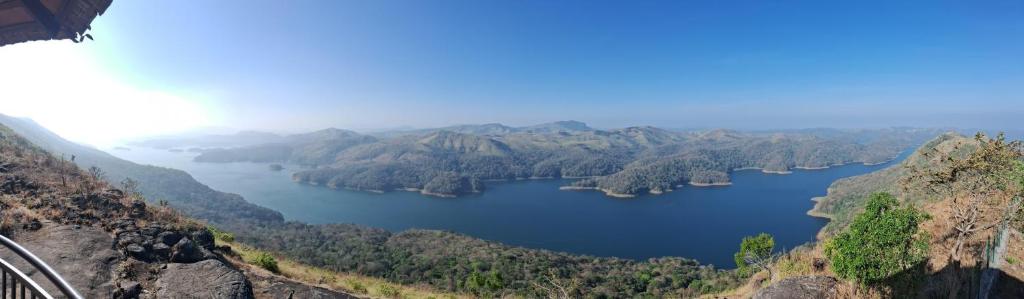 a view of a lake from a mountain at Heritage Farm Kerala in Idukki