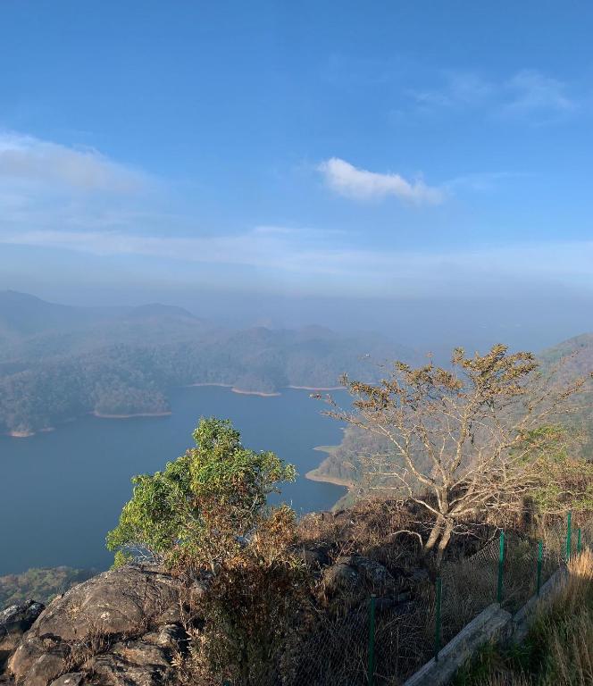 a view of a lake on top of a hill at Heritage Farm Kerala in Idukki