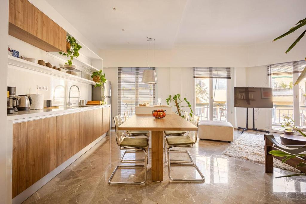 a kitchen with a wooden table and some plants at Marthas Loft Lycabettus Athens in Athens