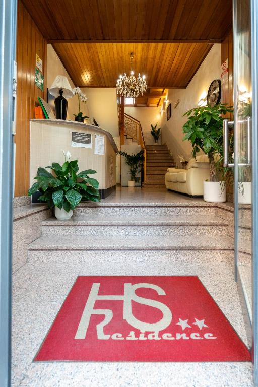 a red welcome mat on the floor of a building at Hotel Residence Sestriere in Moncalieri