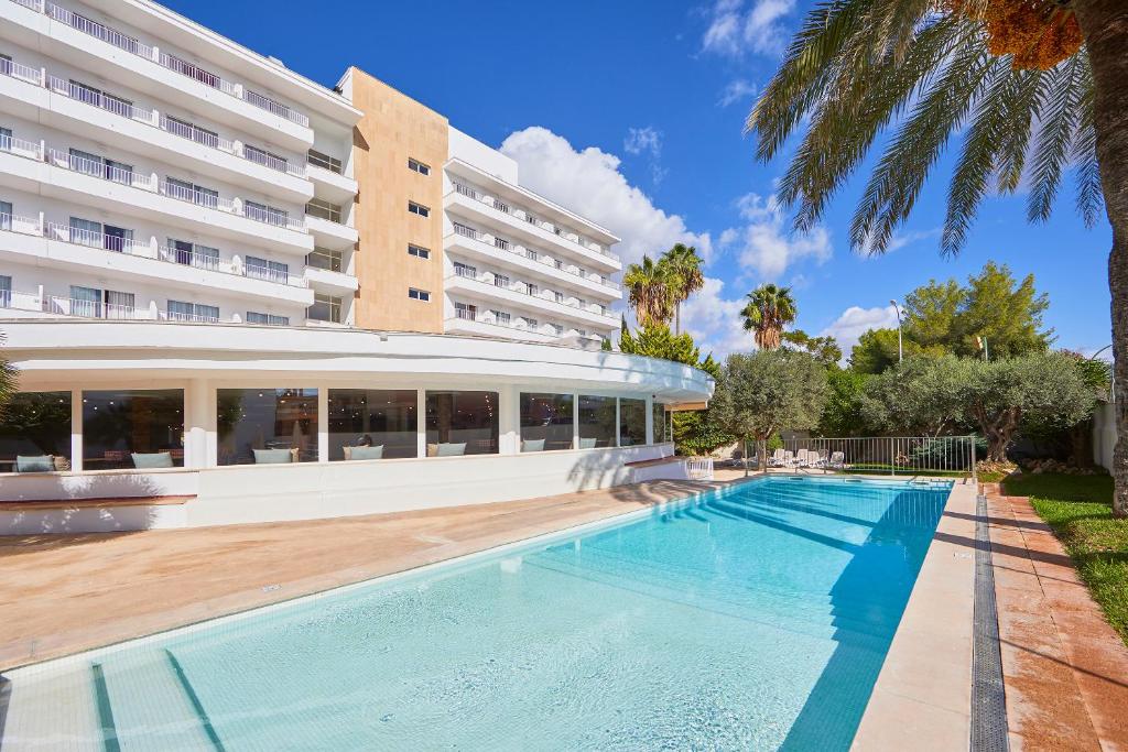 a swimming pool in front of a building at tent Playa de Palma in Playa de Palma