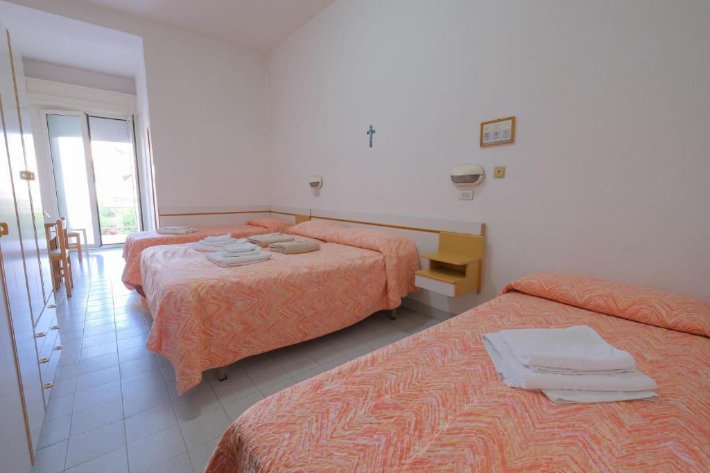 Postel nebo postele na pokoji v ubytování Hotel Alba D'Oro