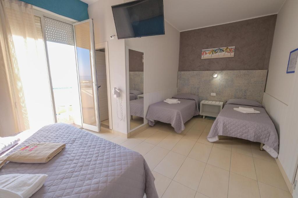Postel nebo postele na pokoji v ubytování Hotel Alba D'Oro