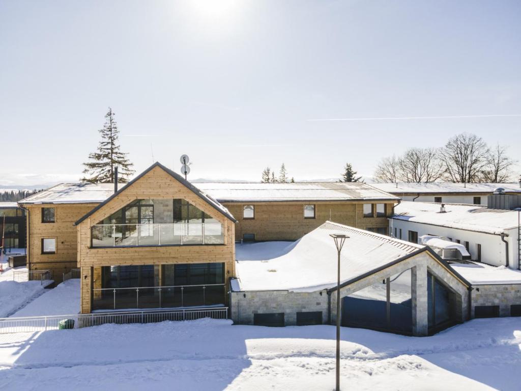 a house in the snow with snow covered roofs at Apartment Confort 223 residence M2 in Tatranska Strba