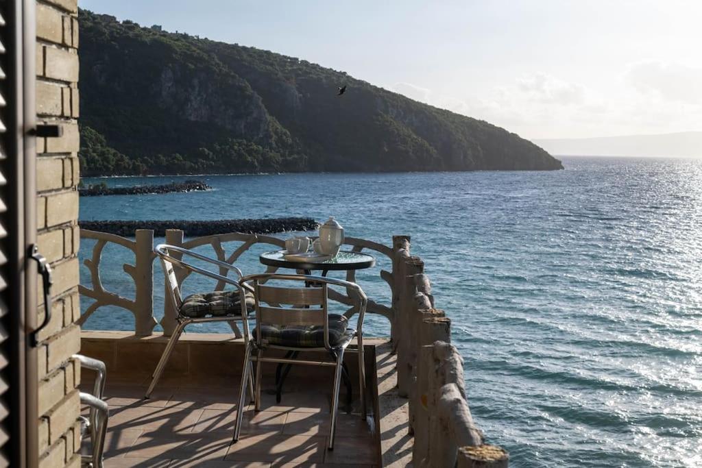 a table and chairs sitting on a balcony overlooking the water at Villa Nerea in Kitriaí