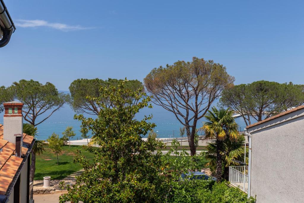 a view of the ocean from a house at Apartments White and Green in Malinska