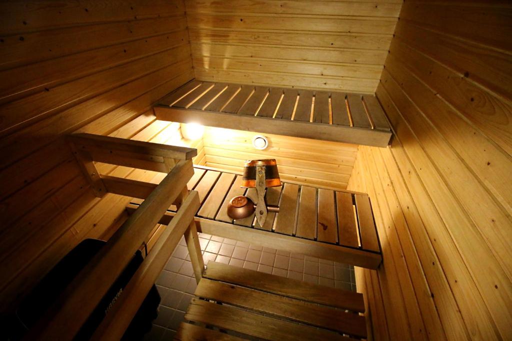 an overhead view of a sauna with a bench and a lamp at Rauhalahti Holiday Homes in Kuopio