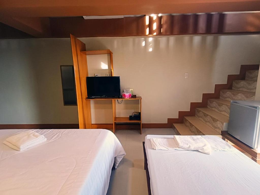 Postel nebo postele na pokoji v ubytování R2R Bayview Inn