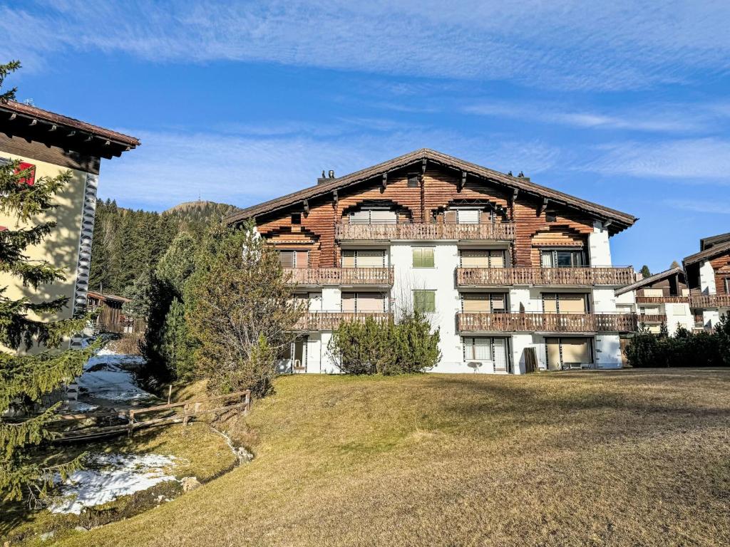 a large brick building with a river in front of it at Apartment Chesa Gop by Interhome in Valbella