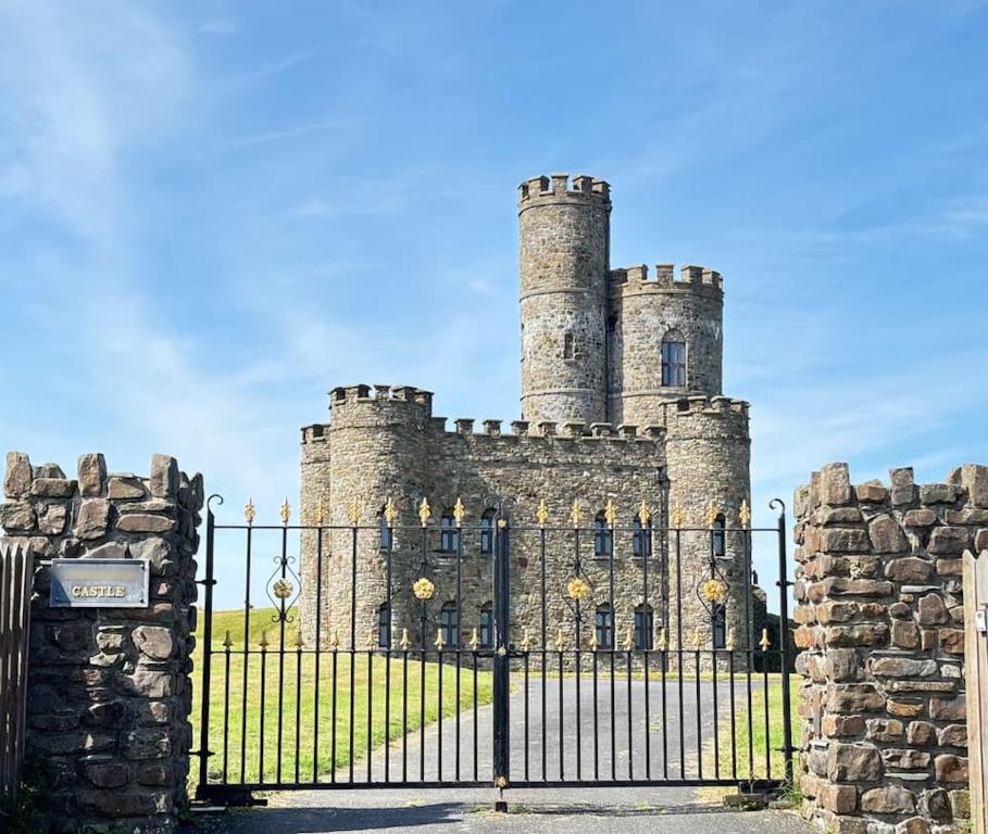 an old castle with a gate in front of it at Romantic Rural Break In Countryside Castle Grounds Private Retreat Wizards Rest in Bishops Tawton
