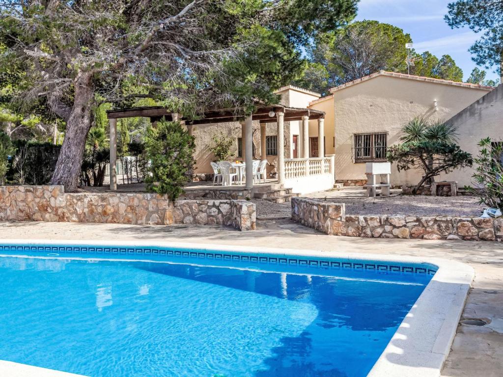 a house with a swimming pool in front of a house at Villa Africa by Interhome in L'Ametlla de Mar