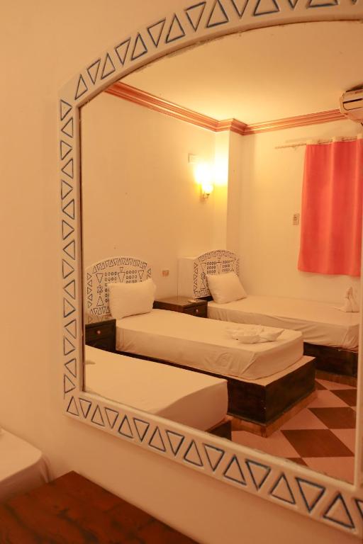 Postel nebo postele na pokoji v ubytování Nubian Kulih house