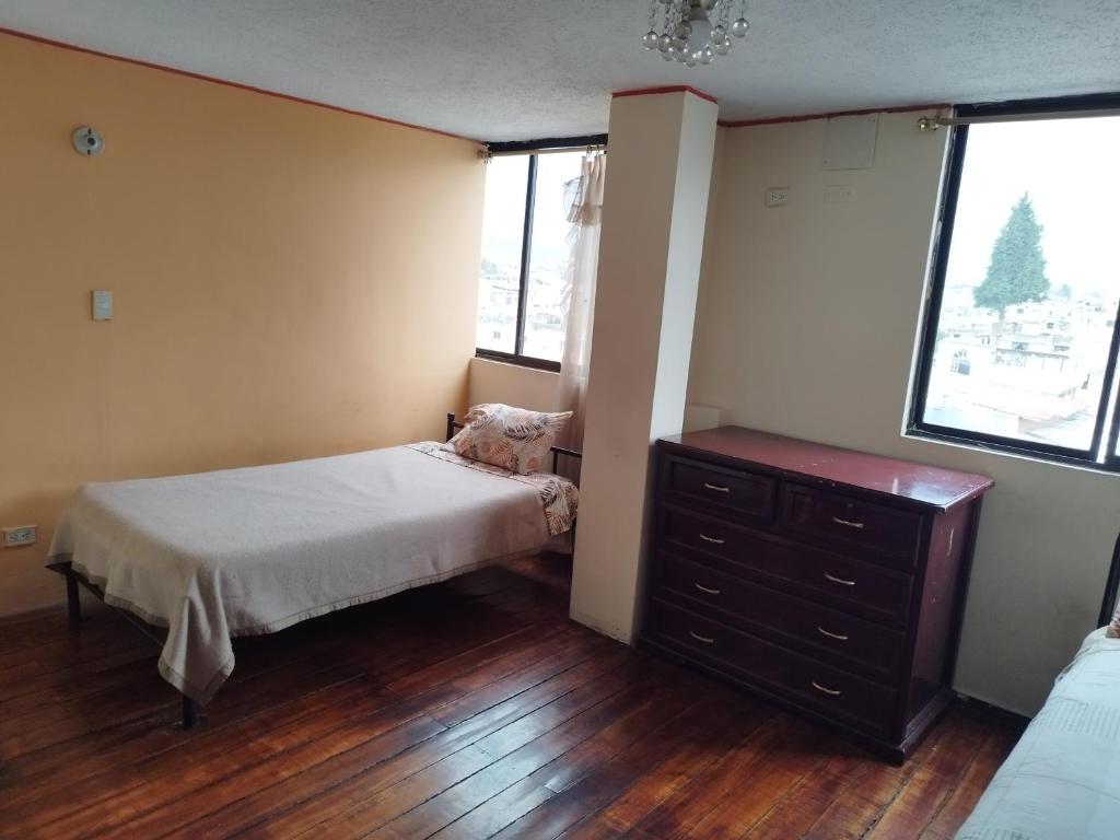 Postel nebo postele na pokoji v ubytování Hostal Terranova Quitumbe