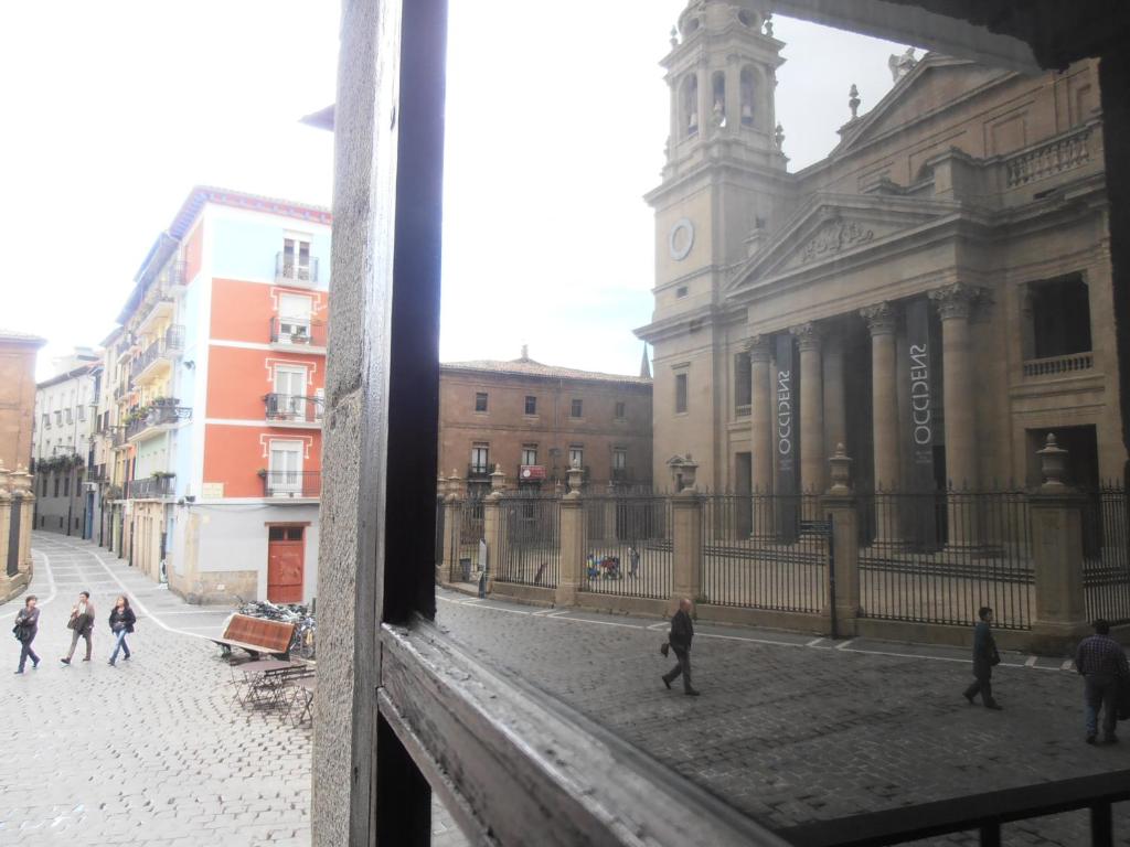 a view of a city street from a window at Plaza Catedral hostel in Pamplona