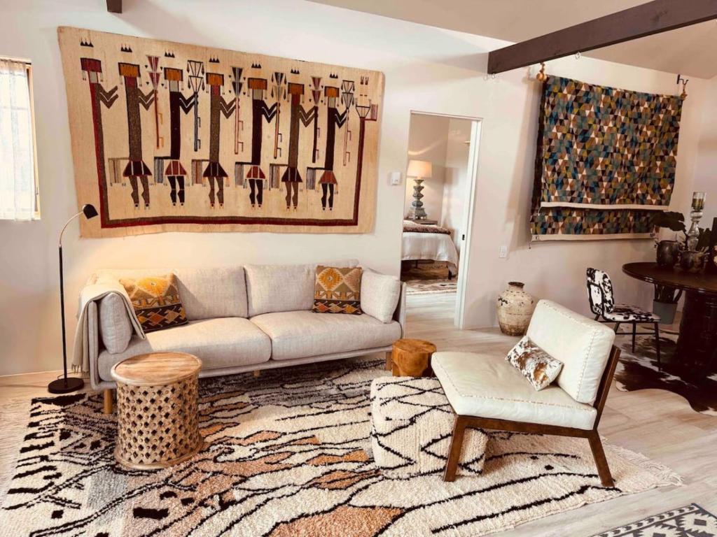 a living room with a couch and a rug at CASA TUA SANTA FE - NM Farmhouse Sanctuary Soaking Room 1 acre private in Santa Fe