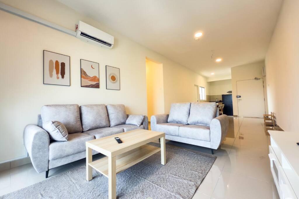 a living room with two couches and a coffee table at Cozy 4B2B for 8 pax - 15 min to Lotus's Mall Kajang in Kampong Paya